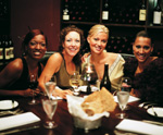 vier fröhliche Frauen beim Abendessen