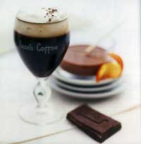 ein irischer Kaffee und ein Stück Schokolade sind angerichtet 
