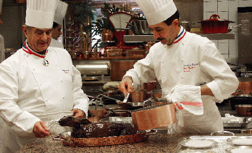Paul Bocuse beim handwerken mit einem Kollegen in der küche 